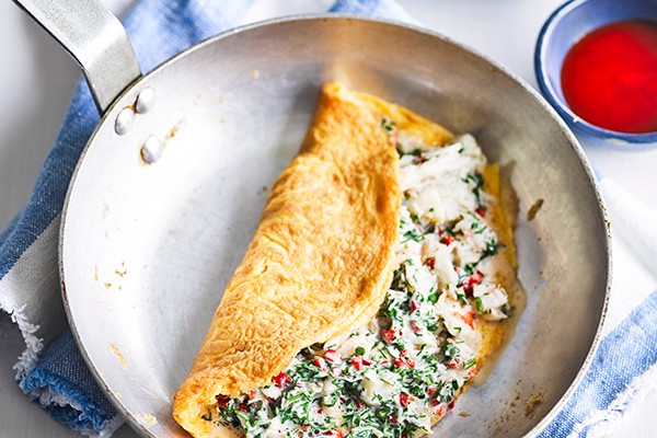 Seafood Omelette Recipe with Chilli served in a silver pan with a side of chilli sauce