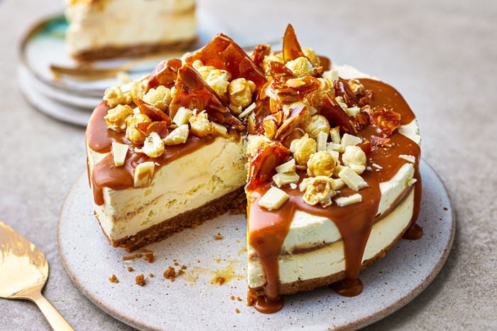 A salted caramel cheesecake with a slice cut out